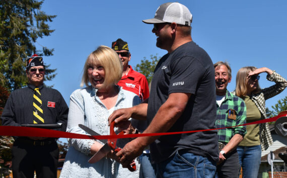 Matthew N. Wells / The Daily World
Linda Springer and Jeff Nations, Cosmopolis’ parks superintendent, cut the red ribbon in a ceremony that welcomed about 60 people to Highland Park. The park has gone through a slew of renovations, including countless hours from community volunteers.