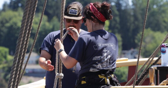 Michael S. Lockett / The Daily World
The Lady Washington’s Chief Mate James Hsu, left, works with Marijo Gauthier-Bérubé as she takes part of a program where nautical archaeology graduate students familiarize themselves with practical sailing aboard the Lady Washington.