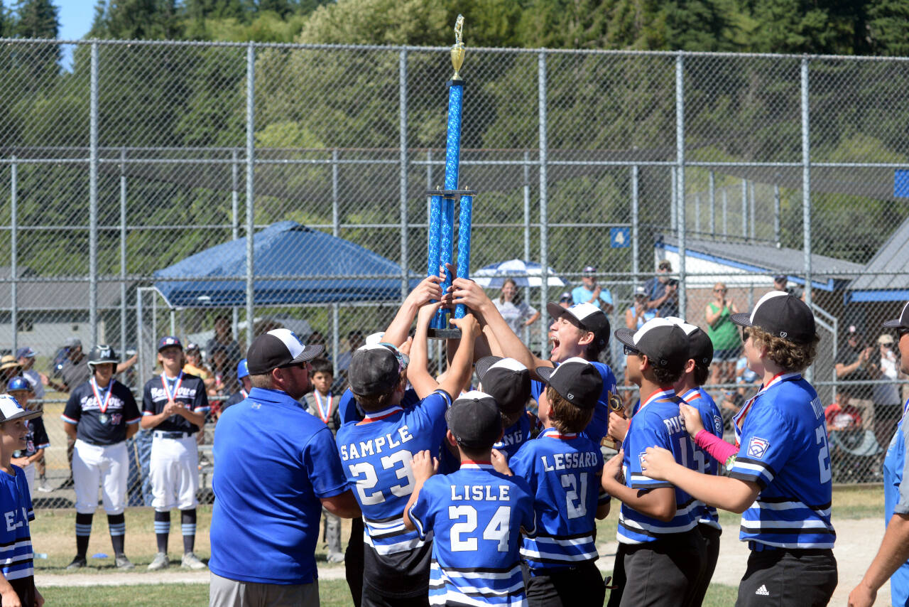 RYAN SPARKS | THE DAILY WORLD The Elma Little League Intermediate all-stars raise the state-championship trophy after sweeping two games against Bellevue National on Saturday at Lloyd Murrey Park in Elma.