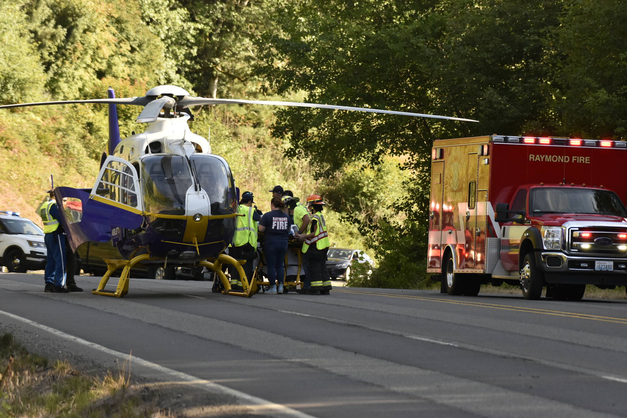 Emergency personnel transport a crash victim onto a Lifeflight helicopter for medevac to a hospital following a single-vehicle motorcycle crash on July 16. (Courtesy photo / Ezra McCampbell)