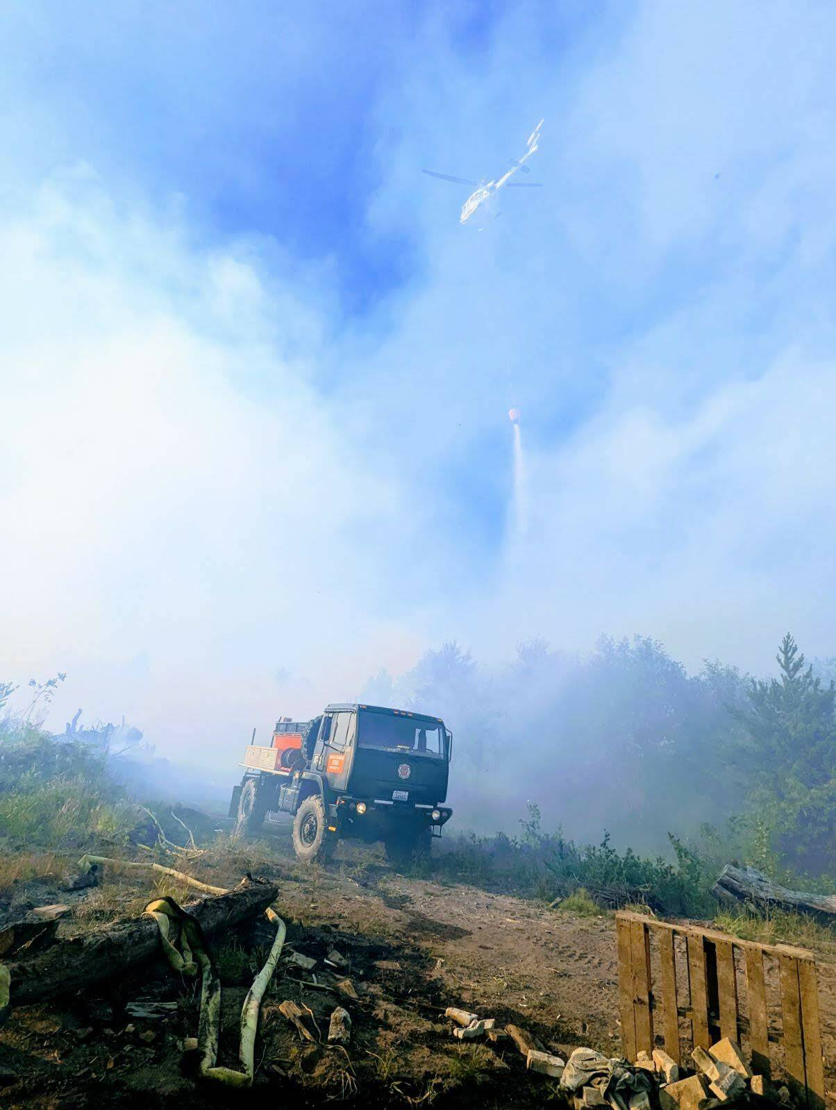 Brush rigs and firefighting helicopters helped fight a wildfire near Pacific Beach on Sunday, July 23. (Courtesy photo / Grays Harbor Fire District 7)