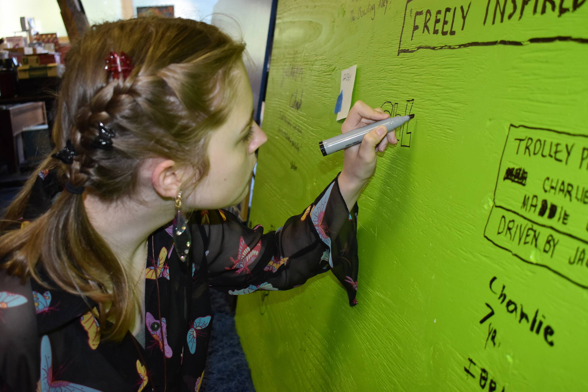 Matthew N. Wells / The Daily World
Chloe Long, a 16-year-old artist from Cosmopolis, signs her name on the back of one of the panels that will hopefully hang on the E Street side of the Cosi Art Center — 1136 1st St., in Cosmopolis. She was part of a collective of young talent who created a heavily-detailed “diptych” of early Cosmopolis that should hang for years to come.