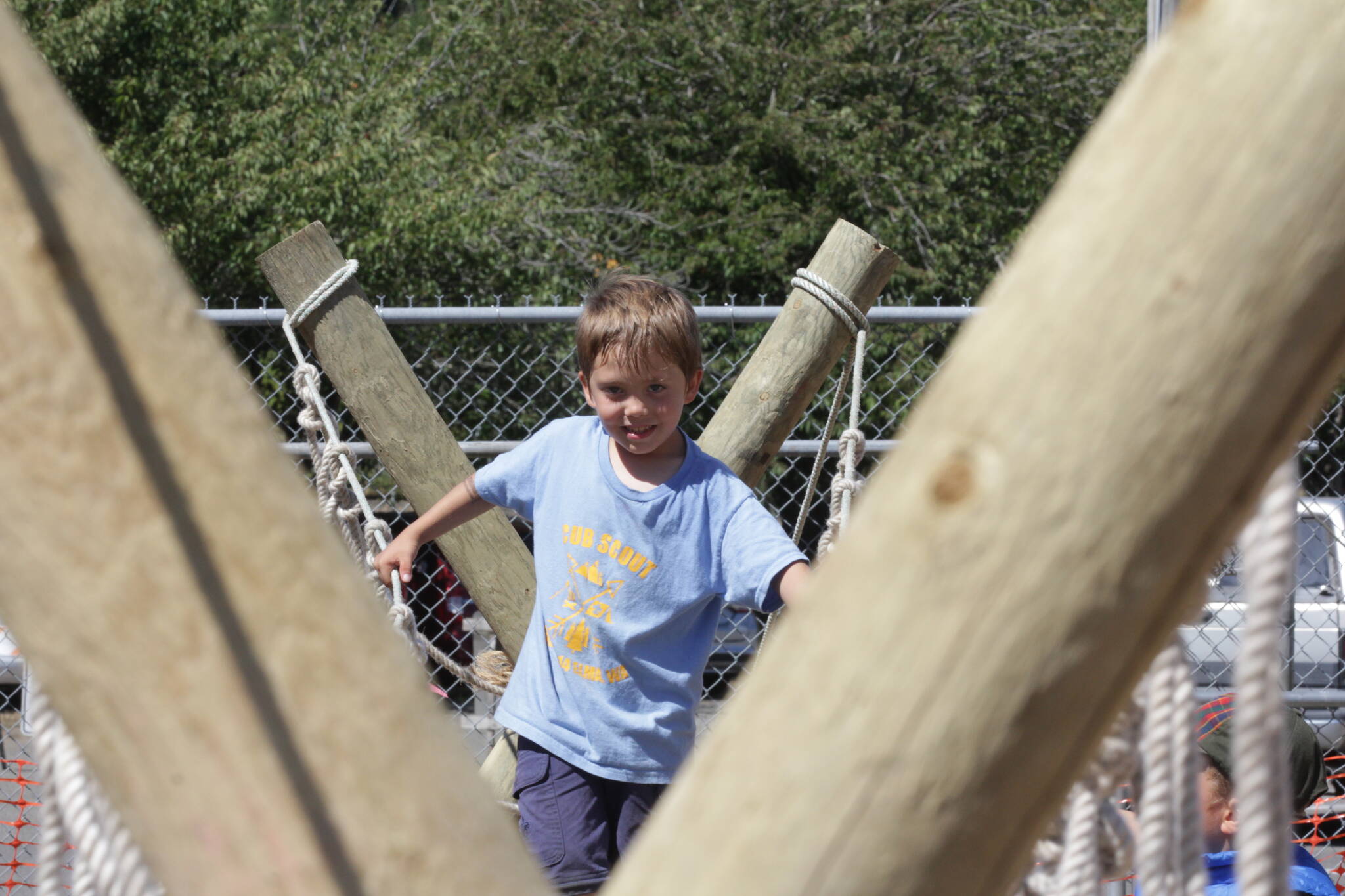 Cub Scout Jaxon Astry crosses a monkey bridge set up by the Scouts during the Grays Harbor County State Fair. (Michael S. Lockett / The Daily World)