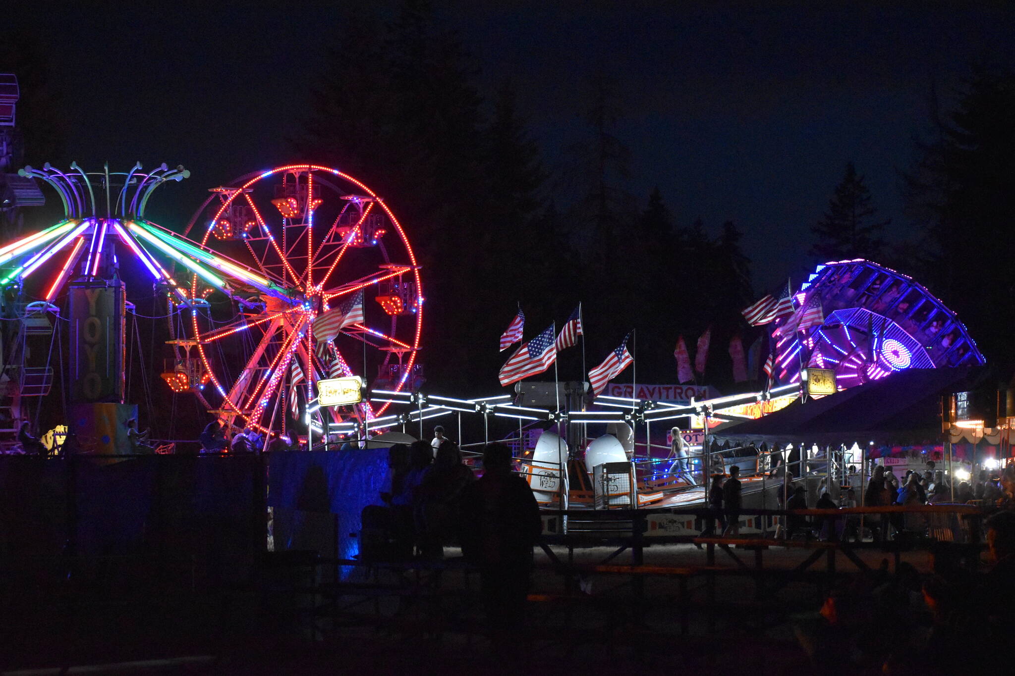 Matthew N. Wells / The Daily World
The Grays Harbor County Fair seen at night shows the variety of colors from a ride called YoYo, the ferris wheel and Gravitron, which spins people around so fast it’s hard to move your arms.