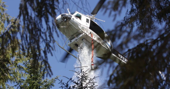 Michael S. Lockett / The Daily World
A helicopter drops water on the Margarita wildfire on Aug. 4.