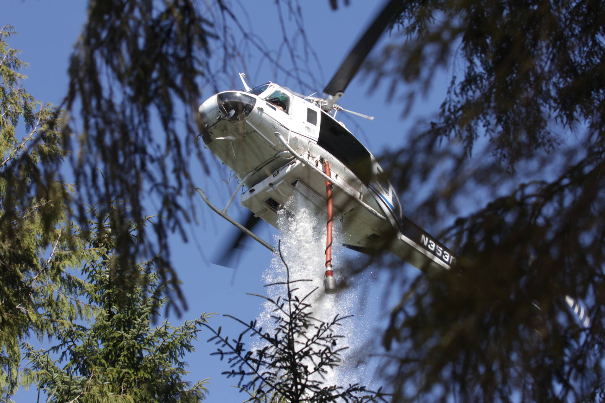 A helicopter drops water on the Margarita wildfire on August 4. (Michael S. Lockett / The Daily World)