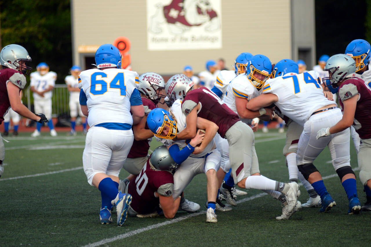 RYAN SPARKS | THE DAILY WORLD Montesano defenders Cam Taylor (50) and Mason Rasmussen tackle a Rochester player during the 15th Annual Montesano Jamboree on Friday at Jack Rottle Field.