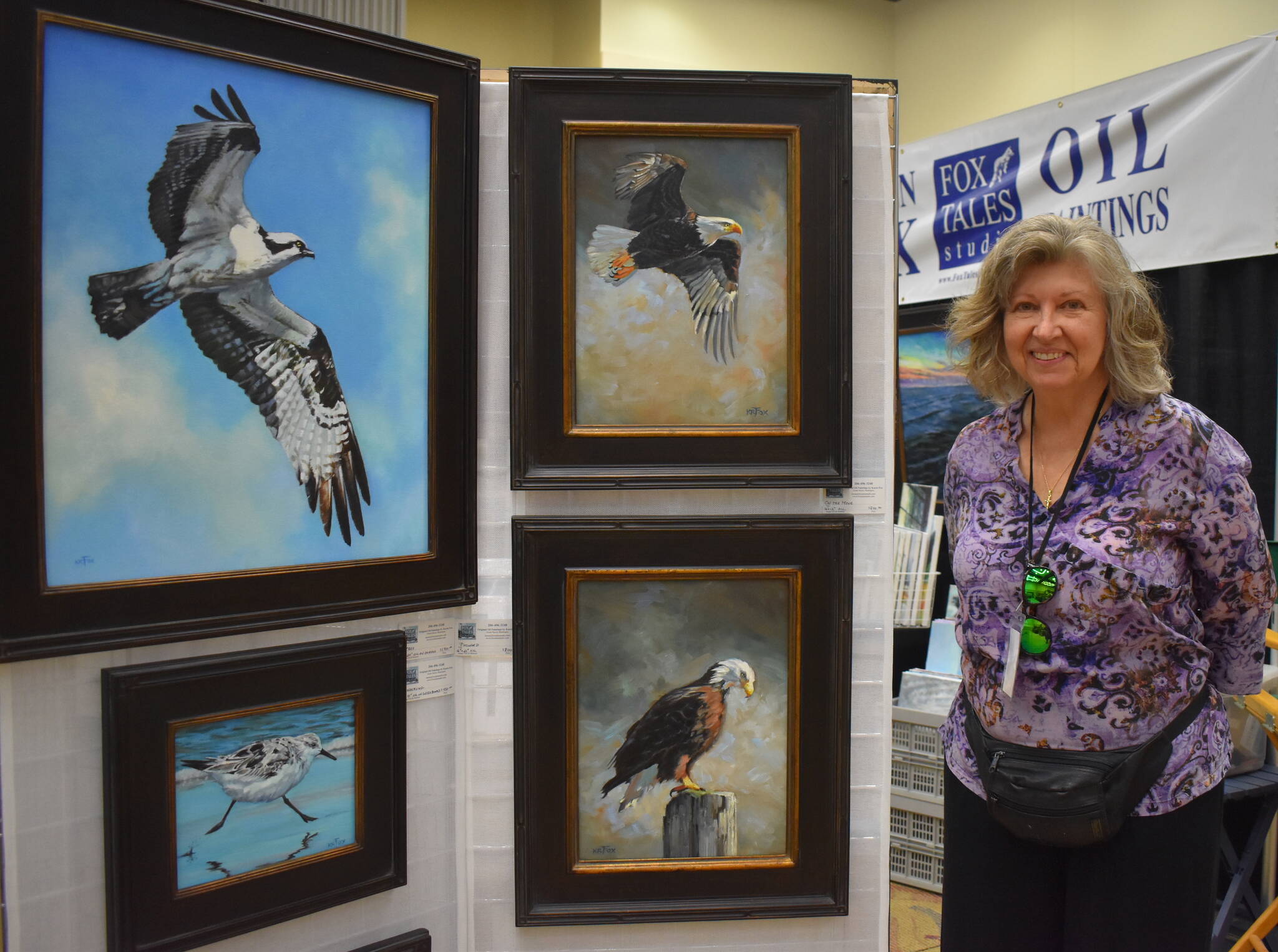 Matthew N. Wells / The Daily World
Karen Fox, who paints animals and vivid nature scenes, stands proudly by a few of her work this past weekend at the 54th annual Associated Arts Ocean Shores Arts & Crafts Festival. Fox has been painting since 1997, but much of her work accelerated during the COVID-19 pandemic. More of her work can be found by searching online for “Fox Tales Studio.”