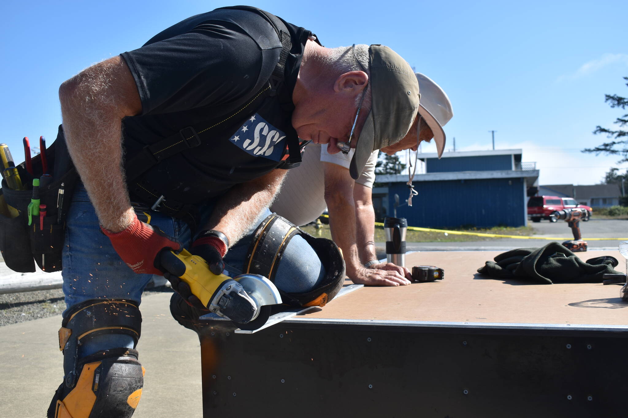 Clayton Franke / The Daily World
Sparks fly from the saw of Gary Pease as he saws a piece of metal to add to the Ocean Shores skatepark on Friday, Sept. 7.