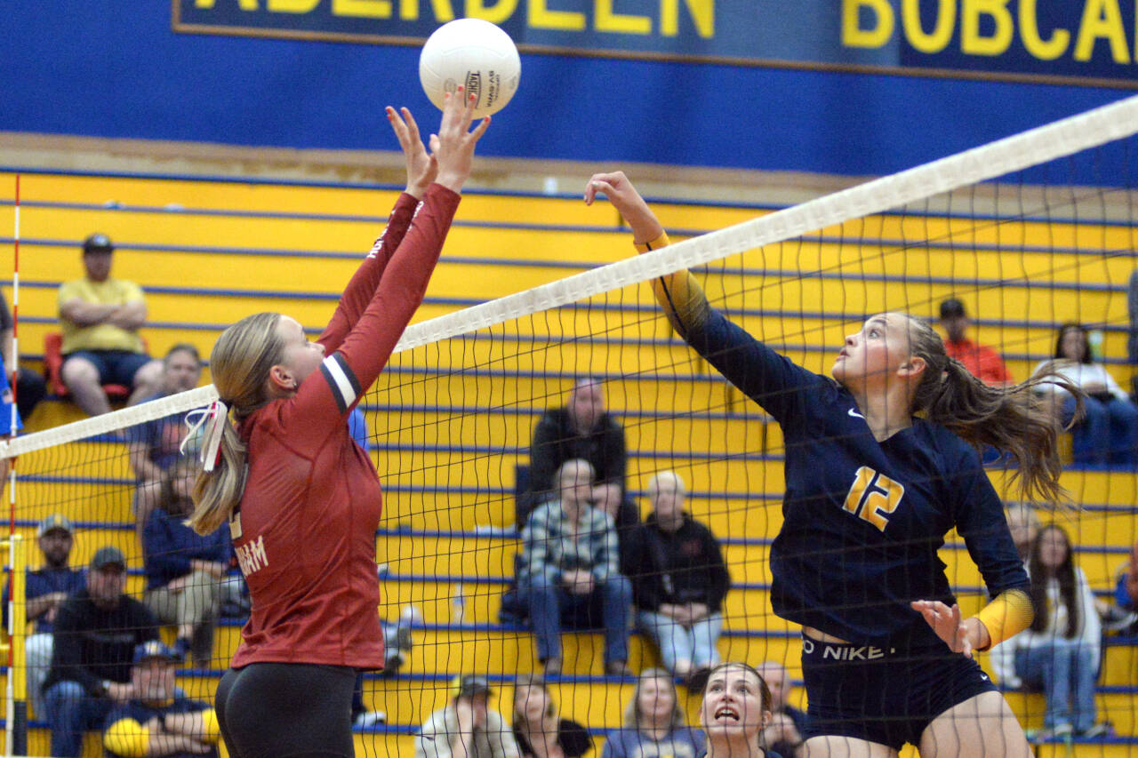 RYAN SPARKS / THE DAILY WORLD 
Aberdeen junior Lilly Camp (12) and Hoquiam senior Kristina Goulet battle at the net during the Bobcats’ victory in five sets on Tuesday at Aberdeen High School.