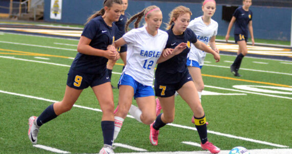 RYAN SPARKS | THE DAILY WORLD
Elma forward Beta Valentine (12) is squeezed by Aberdeen defenders Sawyer Shoemaker (9) and Zoe Troeh during the Eagles' 1-0 victory on Tuesday at Stewart Field in Aberdeen.