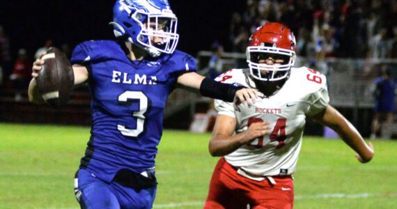 RYAN SPARKS | THE DAILY WORLD Elma backup quarterback Isaac McGaffey (3) looks to throw against Castle Rock defensive lineman Owen Keatley during the Eagles’ 28-10 loss on Friday at Davis Field in Elma.