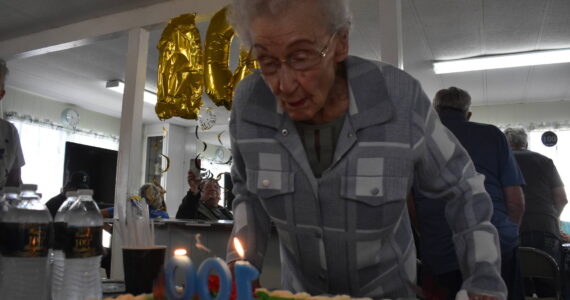 Clayton Franke / The Daily World
Faye Stringer blows out the candles on her 100th birthday cake at a party on Friday, Sept. 15 at Leisure Manor mobile home park in South Aberdeen. Stringer turns 100 on Sept. 26.