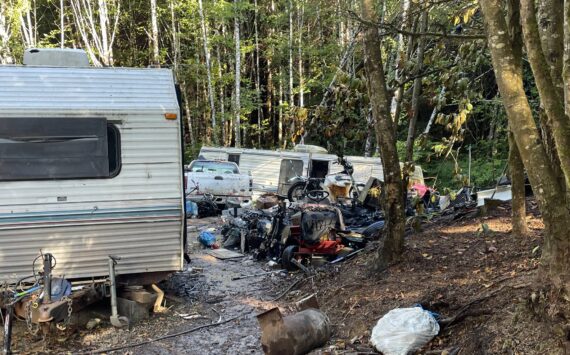 Michael S. Lockett / The Daily World
A fire on Thursday morning completely destroyed a trailer, visible on the right, in a transient camp off state Route 105.