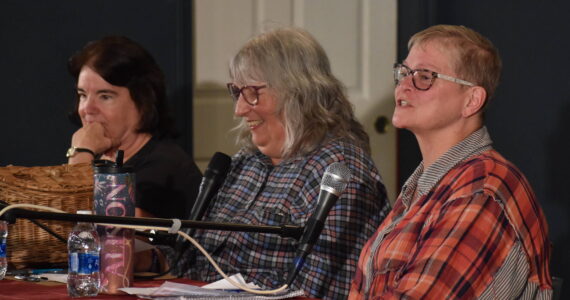 Ocean Shores City Council candidates Caroline Emmert, left, and Alison Cline, right, sit with moderator Gina Rawlings, center, during a forum hosted by Voice of the Shores on Wednesday, Sept. 20 at the Ocean Shores Lions Club. (Clayton Franke / The Daily World)