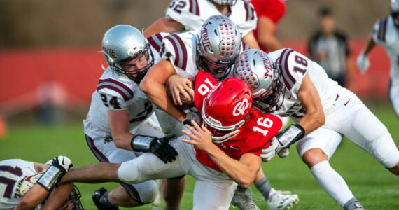PHOTO BY FOREST WORGUM Montesano defenders Tyler Johansen (24), Gabe Bodwell (44) and Toren Crites (18) tackle Castle Rock’s Ryker Heller during the Bulldogs’ 35-7 win on Thursday at Castle Rock High School.