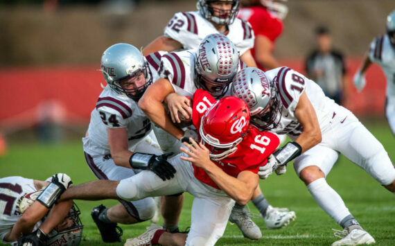 PHOTO BY FOREST WORGUM Montesano defenders Tyler Johansen (24), Gabe Bodwell (44) and Toren Crites (18) tackle Castle Rock’s Ryker Heller during the Bulldogs’ 35-7 win on Thursday at Castle Rock High School.