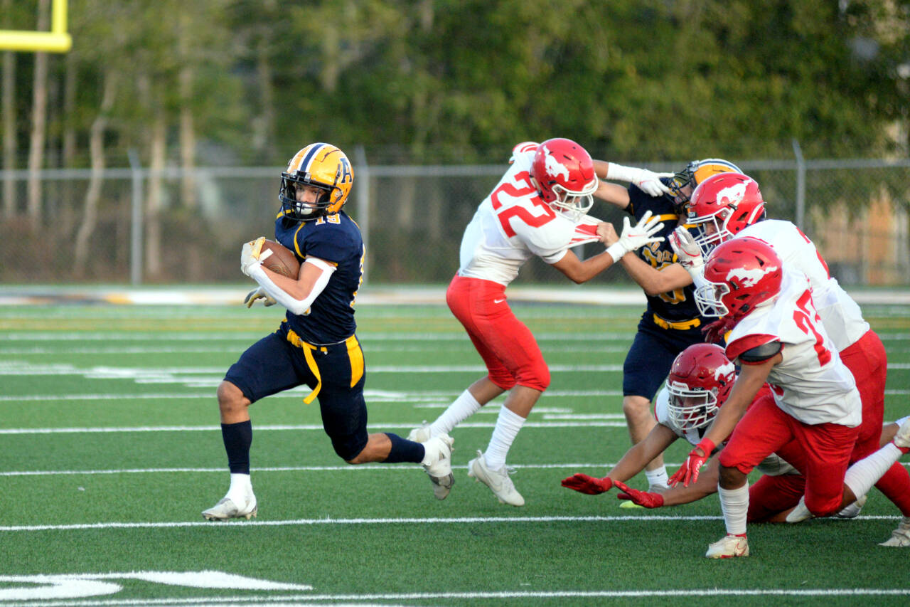RYAN SPARKS | THE DAILY WORLD Aberdeen running back Aidan Watkins, left, sprints around the edge for a big gain in the first quarter of a 27-25 victory over Prosser on Friday in Aberdeen.