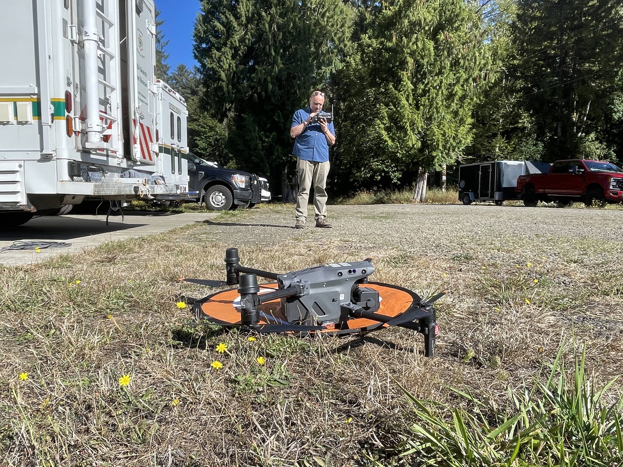 A member of King County’s 4x4 Search and Rescue team prepares to launch a drone during an evidence search in the Oakley Carlson case. (Michael S. Lockett / The Daily World)