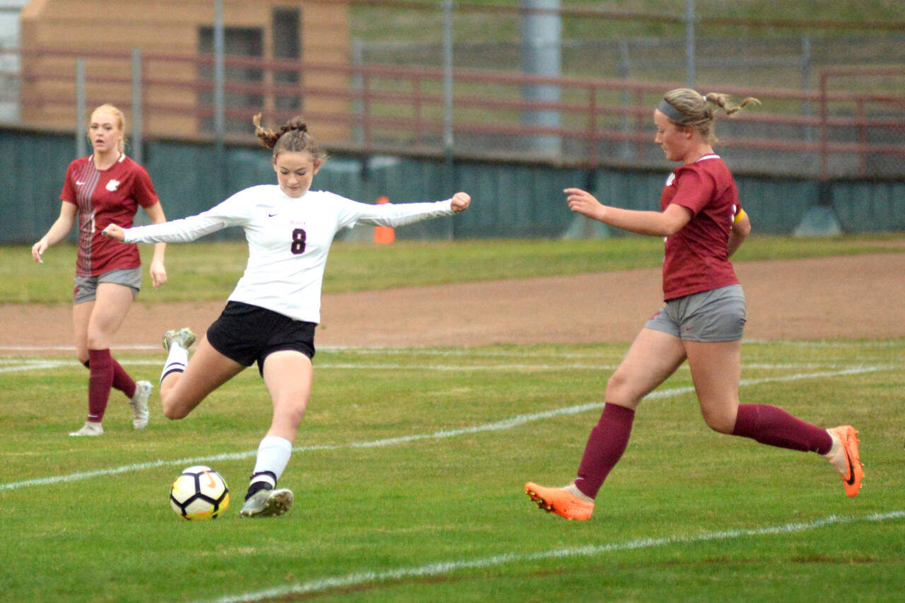 RYAN SPARKS | THE DAILY WORLD Ocosta midfielder Kylee Denny (8) sends the ball forward while Hoquiam’s Paige Shope, right, defends during the Wildcats’ 1-0 win on Thursday at Olympic Stadium in Hoquiam.