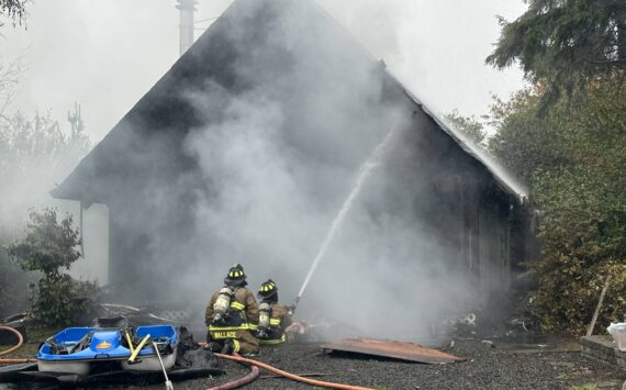Courtesy photo / OSFD
Ocean Shores firefighters attack a house fire on Monday afternoon.