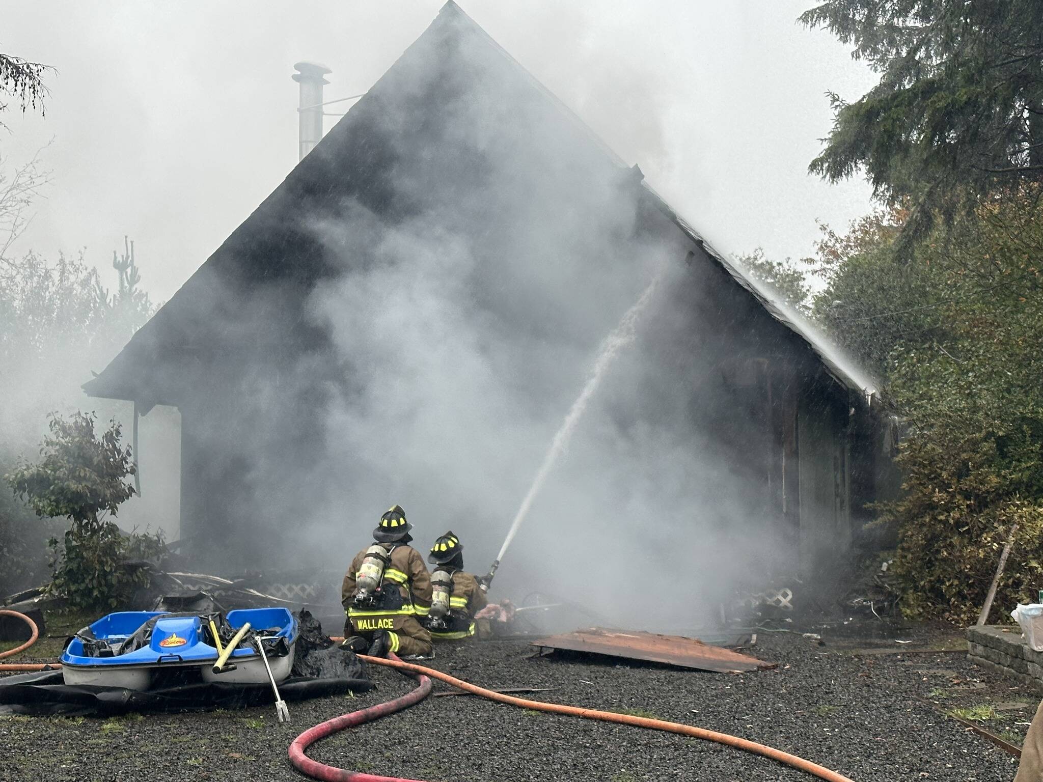 Ocean Shores firefighters attack a house fire on Monday afternoon. (Courtesy photo / OSFD)