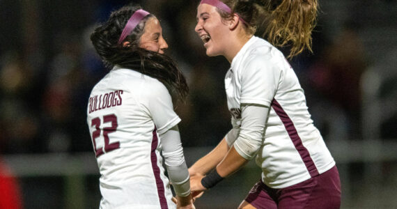 PHOTO BY FOREST WORGUM Montesano’s Sam Roundtree, right, celebrates with teammate Bethanie Henderson after Henderson scored the tying goal late in the second half against Elma on Tuesday at Davis Field in Elma.