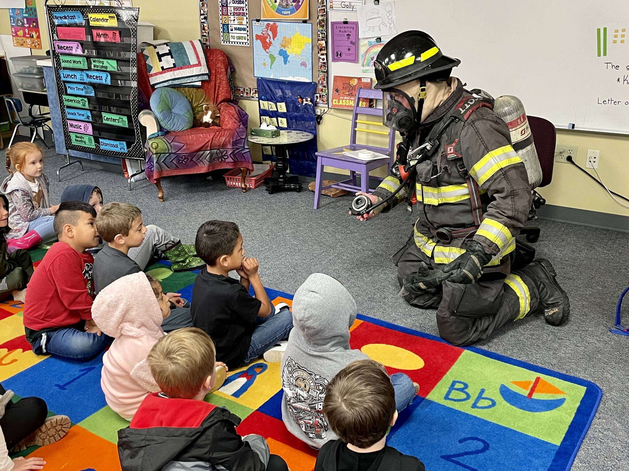 Aberdeen firefighter Kolby Lyle demonstrates his gear to kindergarten students at Robert Gray Elementary on Oct. 10 as part of Fire Prevention Week. (Michael S. Lockett / The Daily World)