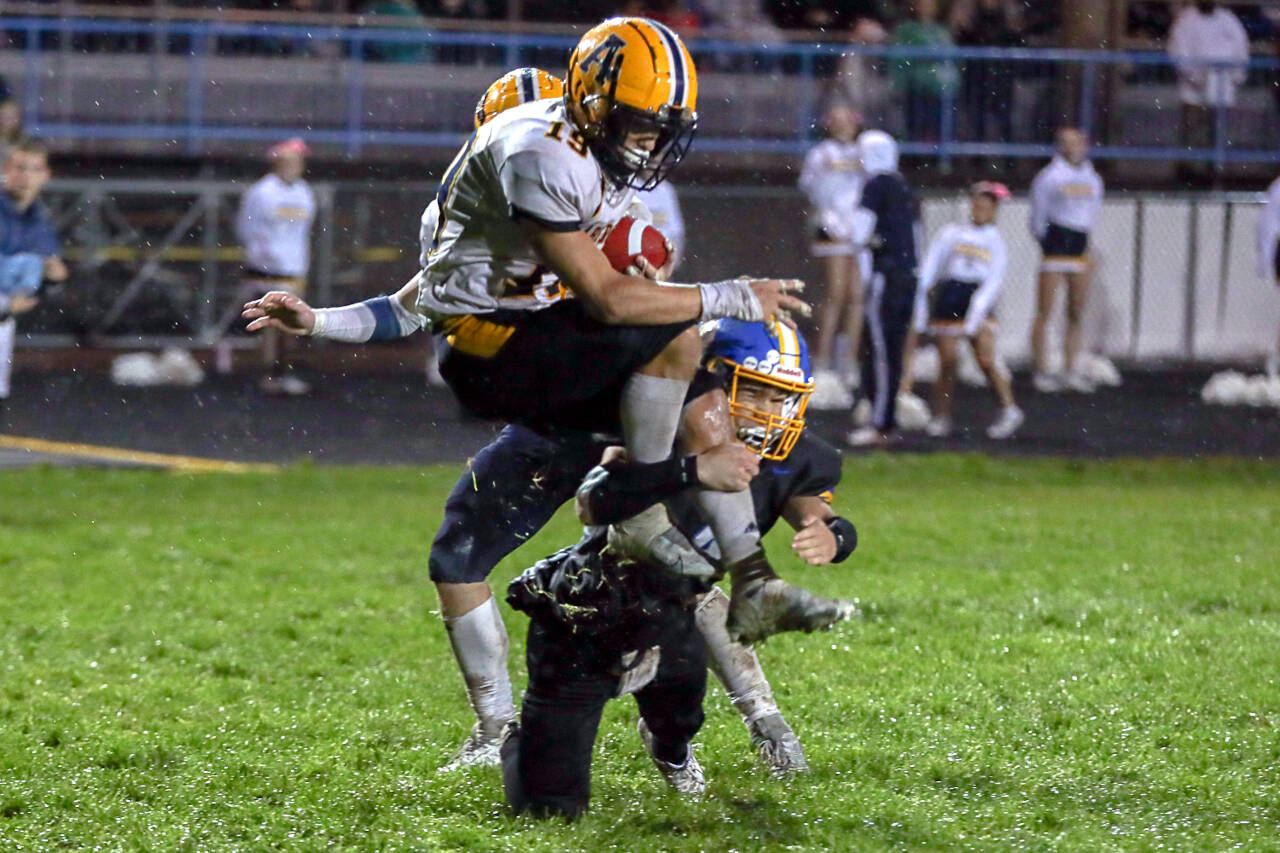 THE CHRONICLE Aberdeen running back Aidan Watkins, top, is tackled by Rochester’s Ashtyn Diamond during a 20-8 win on Friday in Rochester.