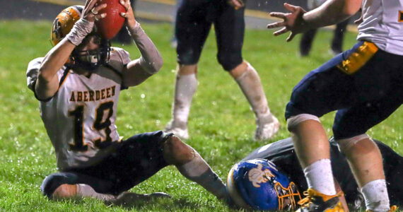THE CHRONICLE Aberdeens’s Aiden Watkins holds the ball up after scoring a toucdown during a 20-8 win over Rochester on Friday in Rochester.
