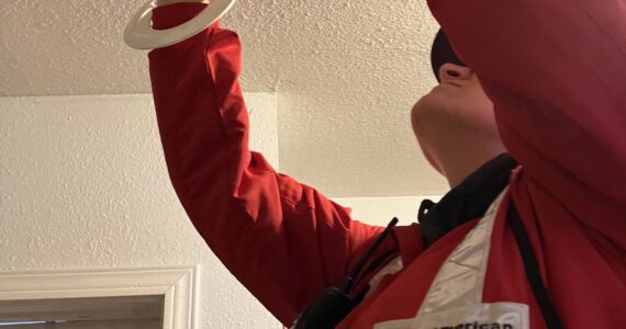 A Red Cross member helps install a smoke detector in a county home on Oct. 21 as part of a push against the region’s high fire risk. (Courtesy photo / Betsy Robertson)