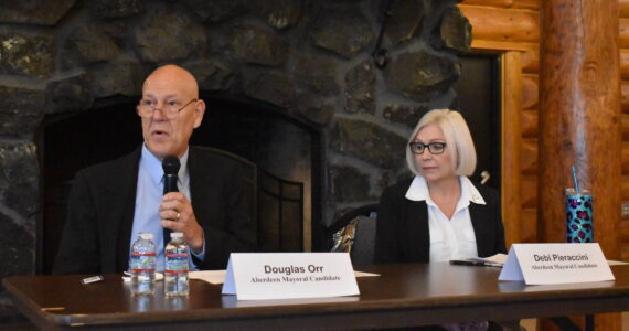 Matthew N. Wells / The Daily World
Douglas Orr and Debi Pieraccini speak at the Aberdeen mayoral candidate’s forum Tuesday at the Rotary Log Pavilion. Both candidates want to improve the city’s direction, and they took the time to share a few of their ideas.