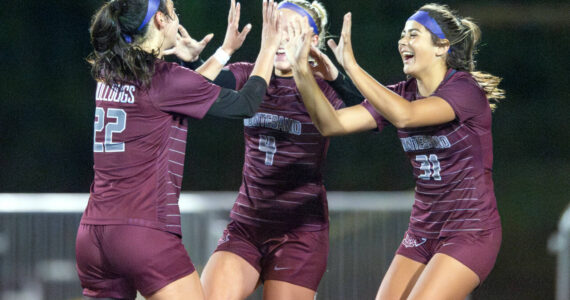 PHOTO BY FOREST WORGUM Montesano’s Bethanie Henderson (22), Addi Kersker (4) and Jaelyn Butterfield (21) celebrate a goal by Henderson late in the Bulldogs’ 3-2 victory over Seton Catholic in the 1A District 4 semifinals on Thursday in Montesano.