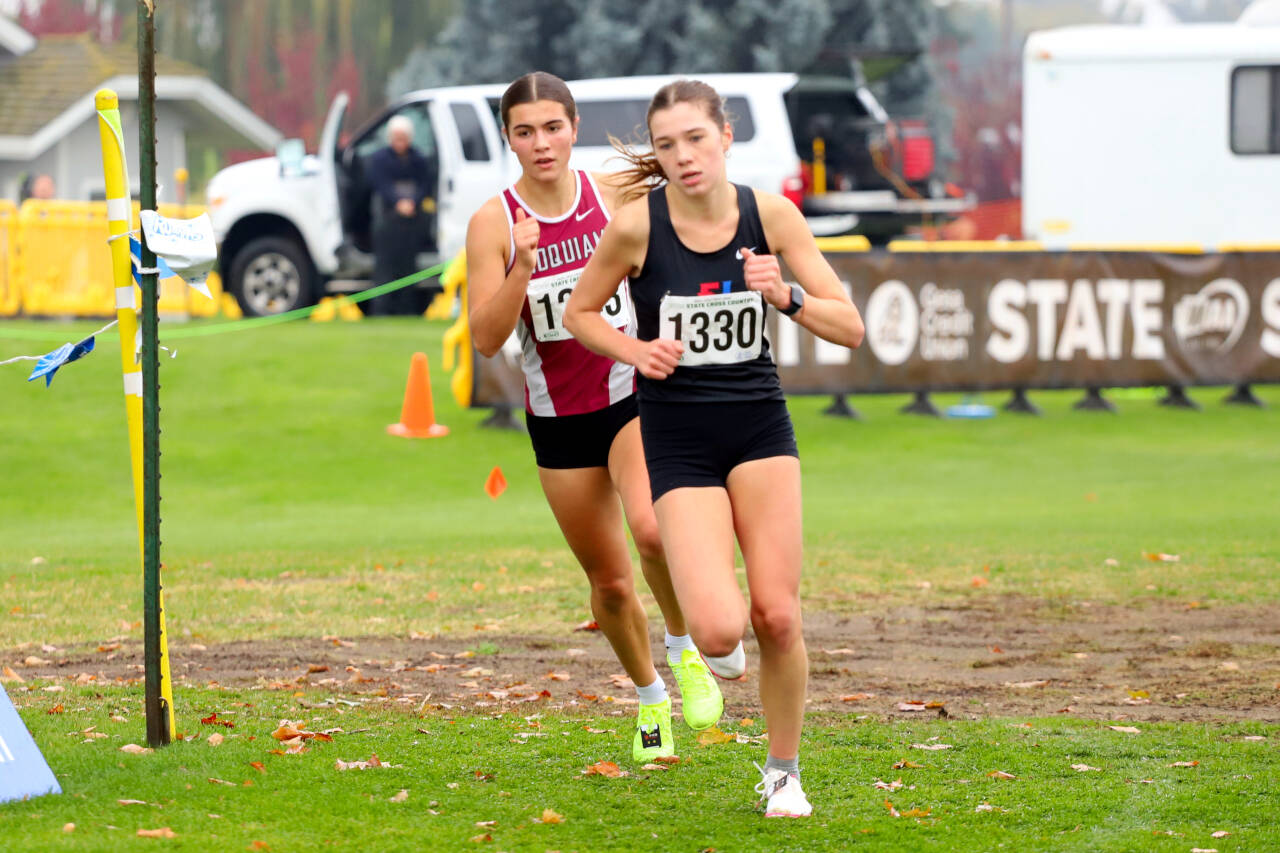 SUBMITTED PHOTO Hoquiam’s Jane Roloff, left, pursues Port Townsend’s Aaliyah Cassidy Yearian during the 1A State Championship girls cross country race on Saturday at the Sun Willows Golf Course in Pasco. Roloff would win the state title with a time of 18:28.00.