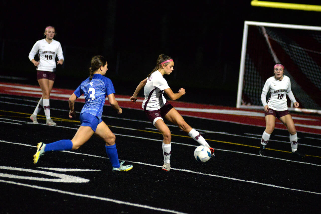 RYAN SPARKS | THE DAILY WORLD Montesano’s Alexa Stanfield, middle, sends the ball forward while under pressure from La Center’s Bailey McIntosh (3) during the Bulldogs’ 3-0 loss in the 1A District 4 Championship game on Saturday in Tenino.