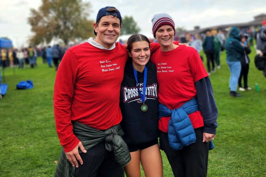 SUBMITTED PHOTO Hoquiam senior Jane Roloff, middle, celebrates winning the 1A State girls cross-country championship with father Casey, left, and mother Laura on Saturday at the Sun Willows Golf Course in Pasco.