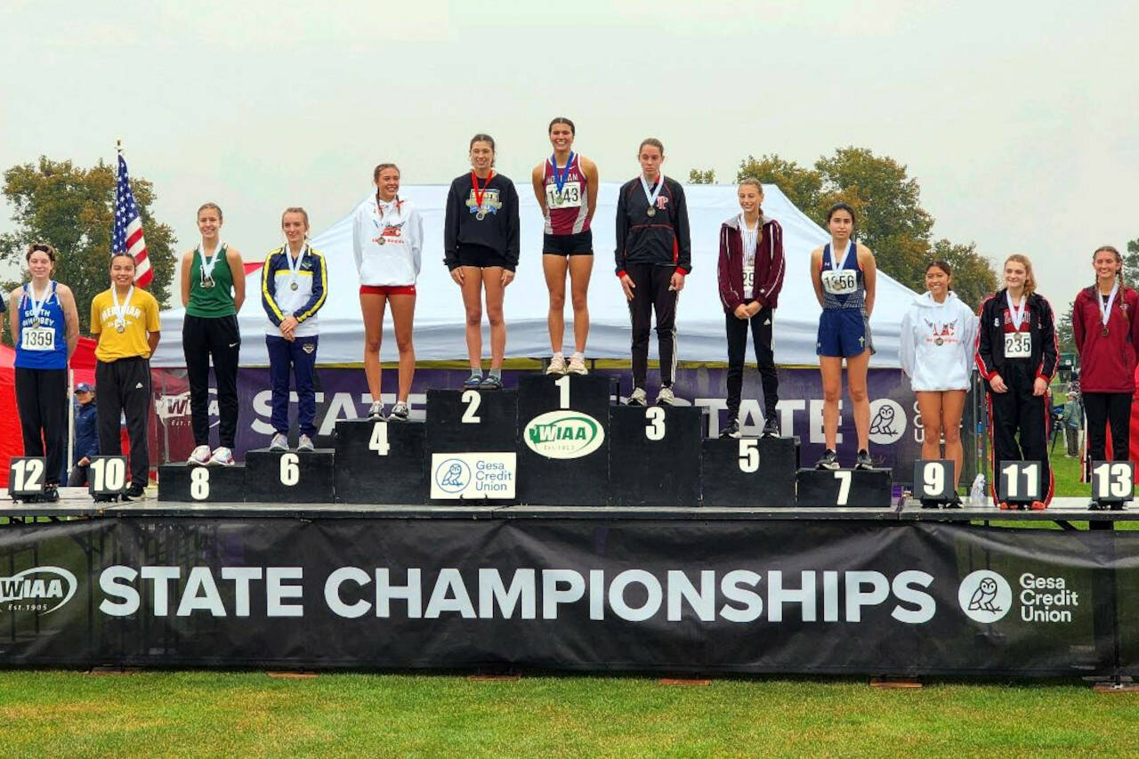 SUBMITTED PHOTO Hoquiam’s Jane Roloff (1) stands atop the podium after winning the state title at the 1A State Championship girls cross-country meet on Saturday at the Sun Willows Golf Course in Pasco.