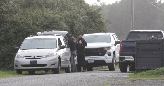 Personnel from the Grays Harbor Sheriff’s Office talk to local residents seeking more information following a shooting in Moclips on Nov. 6. (Michael S. Lockett / The Daily World)