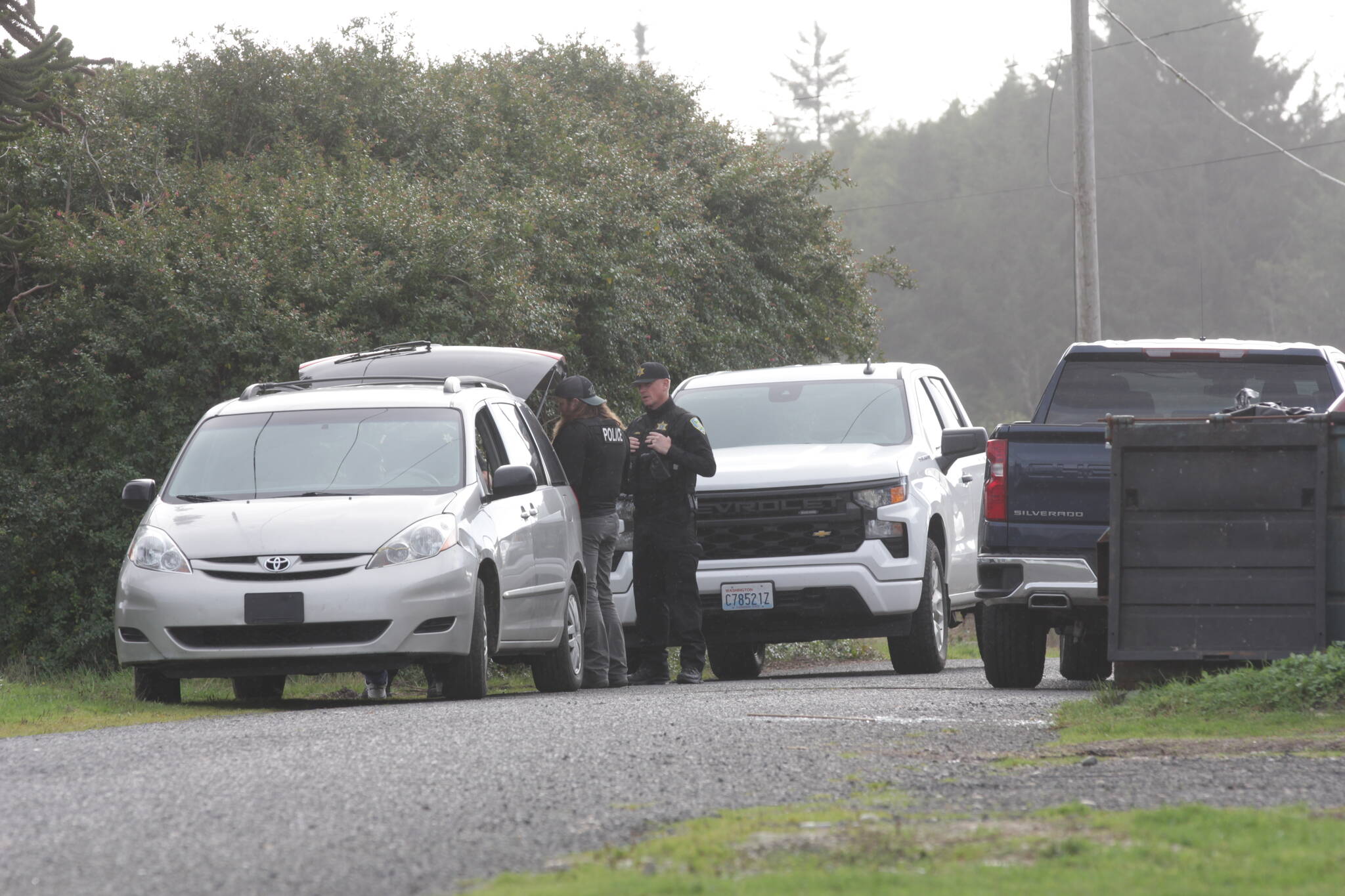 Personnel from the Grays Harbor Sheriff’s Office talk to local residents seeking more information following a shooting in Moclips on Nov. 6. (Michael S. Lockett / The Daily World)