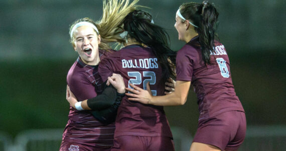 PHOTO BY FOREST WORGUM Montesano’s Kennedy Campbell, left, and Adda Potts (8) celebrate a goal by Bethanie Henderson (22) during the Bulldogs’ victory over Bellevue Christian in a 1A State first-round game on Wednesday in Montesano.