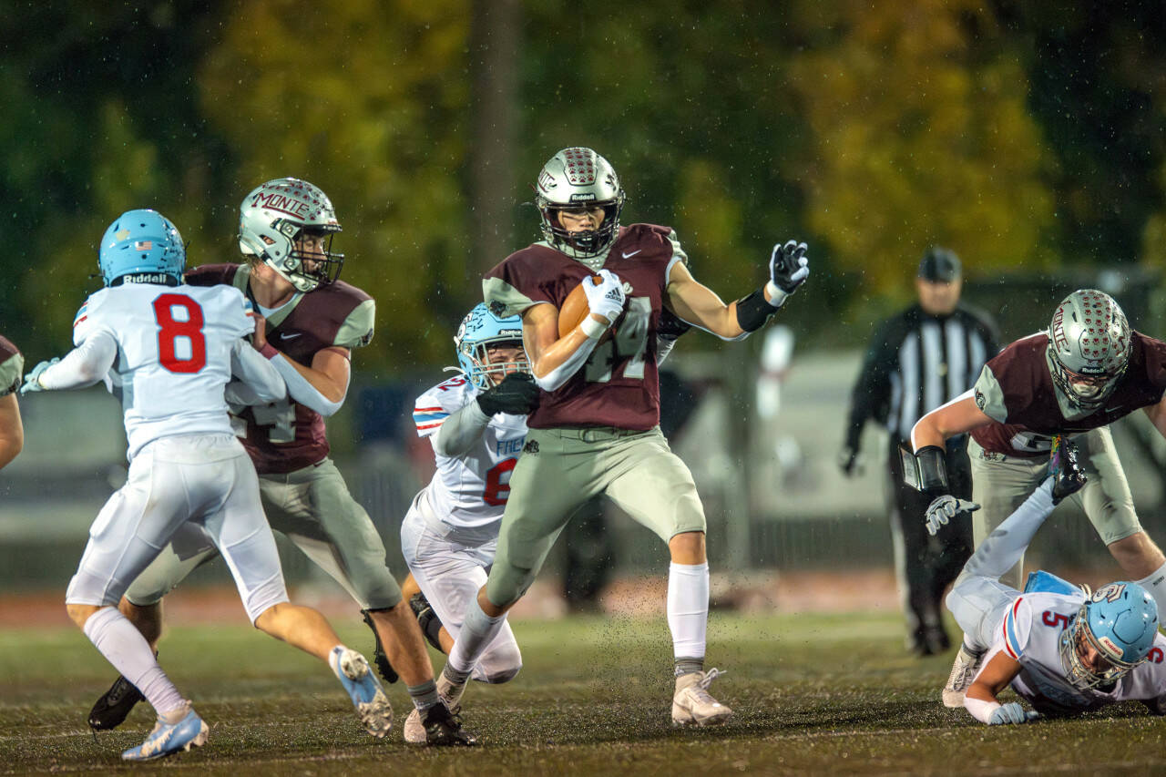 PHOTO BY FOREST WORGUM Montesano running back Gabe Bodwell (44) gets a block from teammates Tyler Johansen (24) and Cohen Andersen, right, during a 28-21 loss to Freeman in a 1A State first-round playoff game on Friday in Montesano.