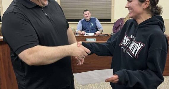 Hoquiam City Council
Hoquiam Mayor Ben Winkelman, left, shakes Hoquiam High School senior Jane Roloff’s hand after a city proclamation he read to honor the athlete during the Hoquiam City Council meeting on Monday. Dave Hinchen, Hoquiam city councilor, looks on with a smile, too.