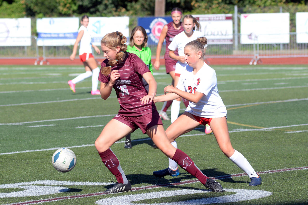 DAILY WORLD FILE PHOTO Montesano midfielder Hazel Jones, left, shields a Seattle Academy player during a game on Sept. 9 in Montesano. The Bulldogs face the Cardinals in a 1A State semifinal game on Friday in Tacoma.
