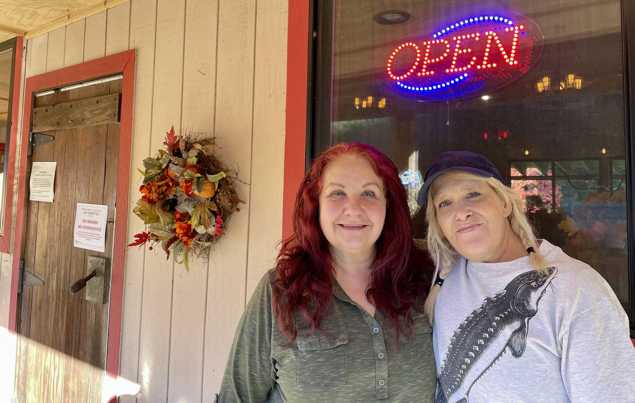 Michael S. Lockett / The Daily World
Artic Pub owner Lisa Loveday, center, and longtime bartender Jackie Duncan smile outside the bar, recently reopened following a major fire.