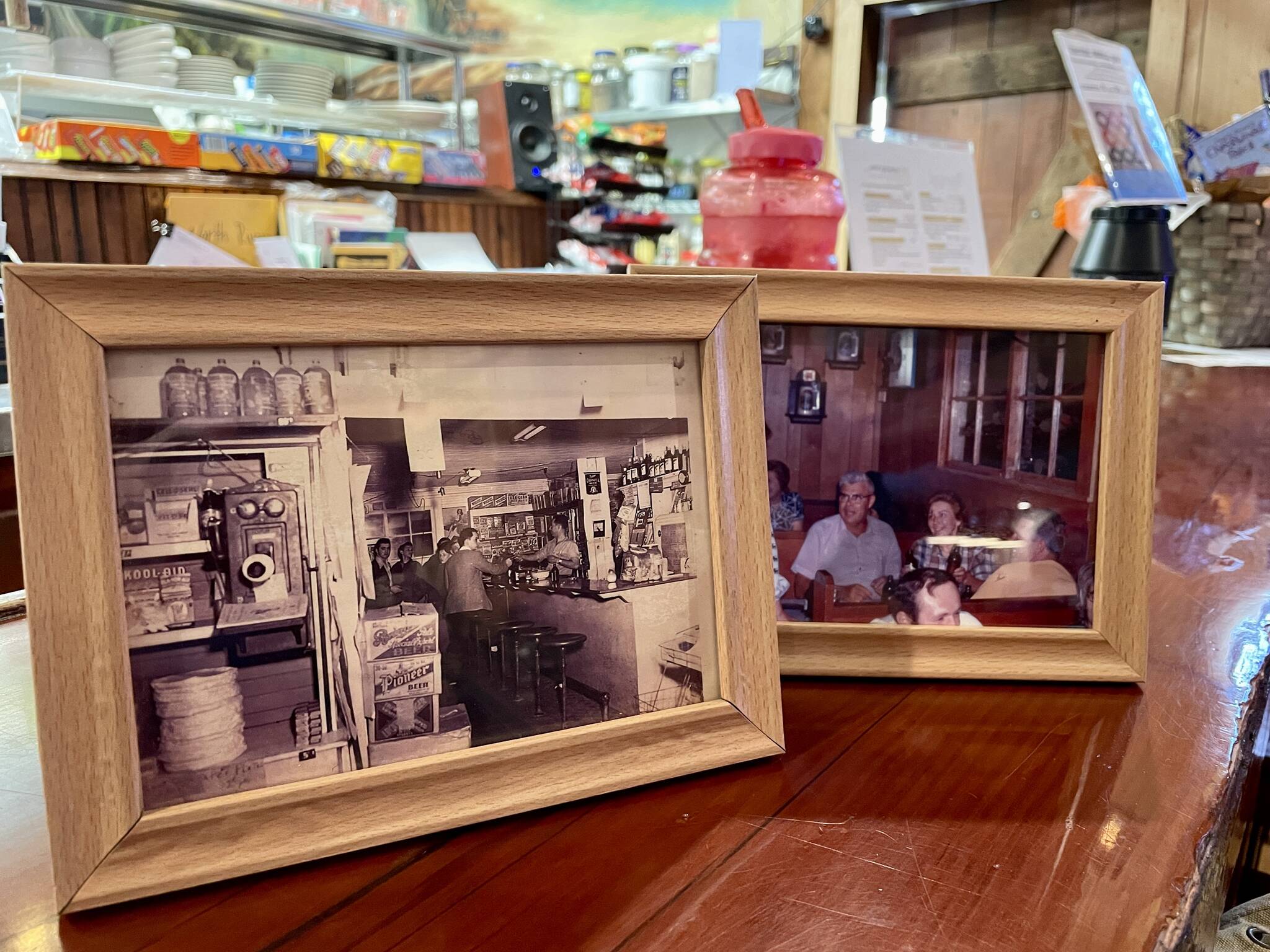 Old photos of previous incarnations of the bar now called the Artic Pub are on displayed in the recently reopened bar. (Michael S. Lockett / The Daily World)