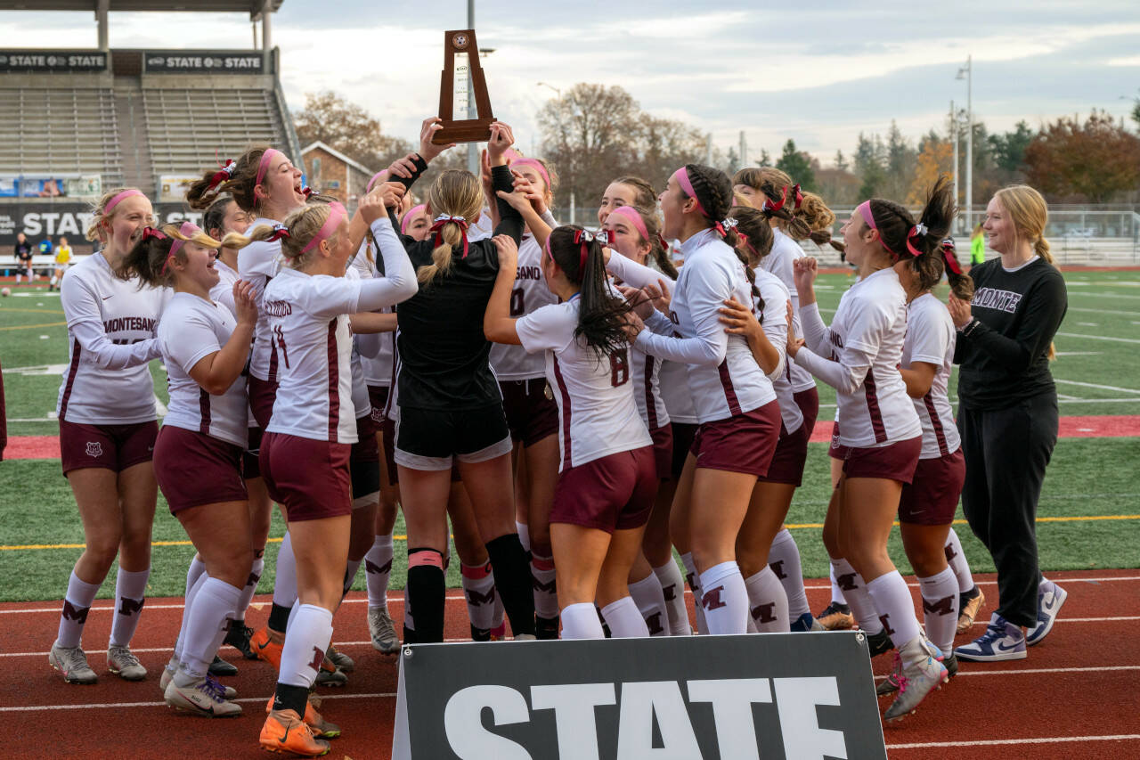 PHOTO BY FOREST WORGUM The Montesano Bulldogs raise their state third-place trophy after beating La Center 3-1 in the 1A State Tournament on Saturday at Mount Tahoma High School in Tacoma.