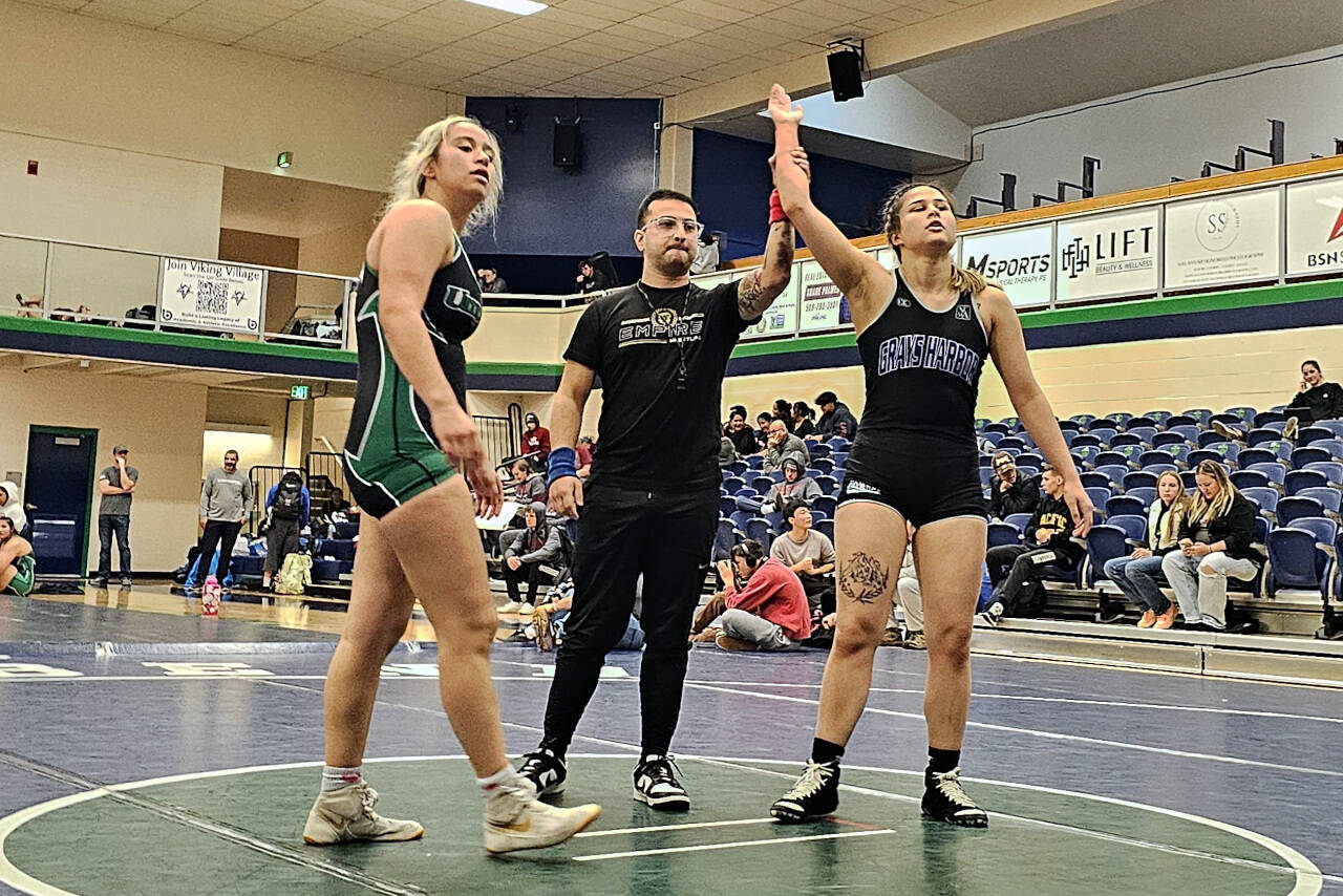 SUBMITTED PHOTO Grays Harbor College’s Georgia Ustaszewski, right, has her hand raised after earning a victory at the Spokane Open on Sunday in Spokane.