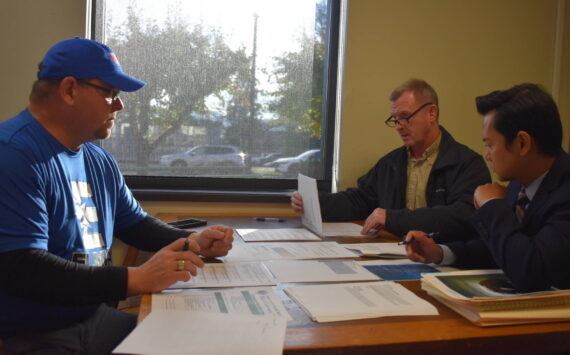 From left: Grays Harbor County Auditor Joe Maclean, Commissioner Kevin Pine and Deputy Prosecuting Attorney Jon Beltran examine and certify election results Tuesday afternoon. The three county officials were serving as up the Grays Harbor County Canvassing Board. (Clayton Franke / The Daily World)