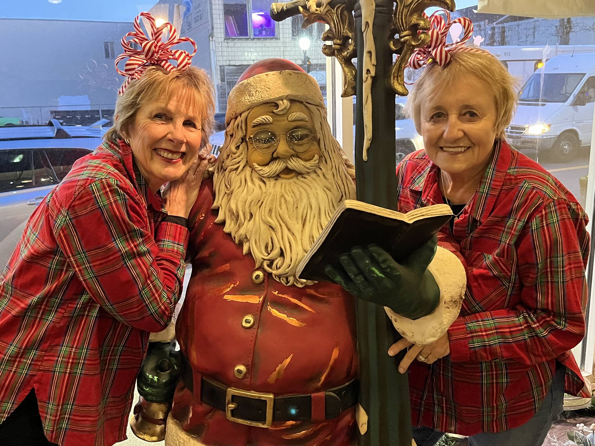 Matthew N. Wells / The Daily World
Santa checks his list as Downtown Aberdeen Association’s Bette Worth, left, and Bobbi McCracken pose next to the jolly, old elf. Soon, the real St. Nick will appear at Messy Jessy’s Bar and Grill — 212 S. I St., for a pancake breakfast starting at 9 a.m. Saturday to kick off Winterfest.