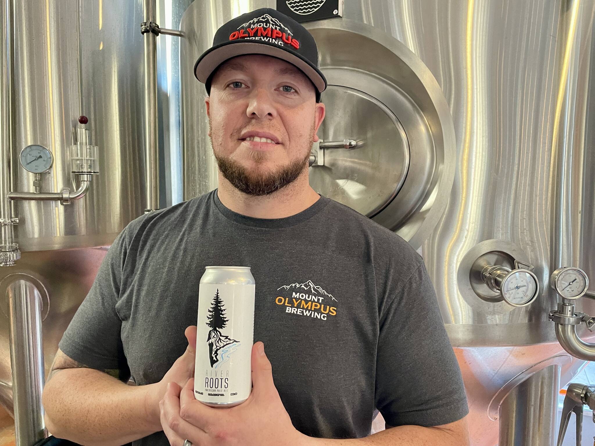 Michael S. Lockett / The Daily World
Head brewer and owner of Mount Olympus Brewery Orlando Maldonado poses with the beer they partnered with the Grays Harbor Conservation District on.